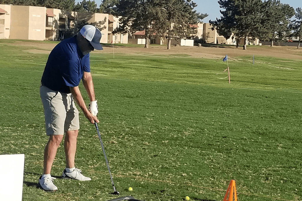 Golfer taking a swing on practice range